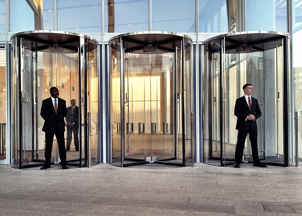 "London, UK - 14 September 2012: Smartly dressed security staff standing by the London Bridge train station entrance to the Shard building."