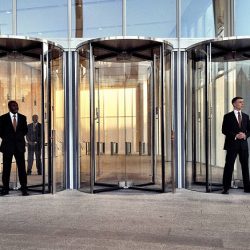 "London, UK - 14 September 2012: Smartly dressed security staff standing by the London Bridge train station entrance to the Shard building."